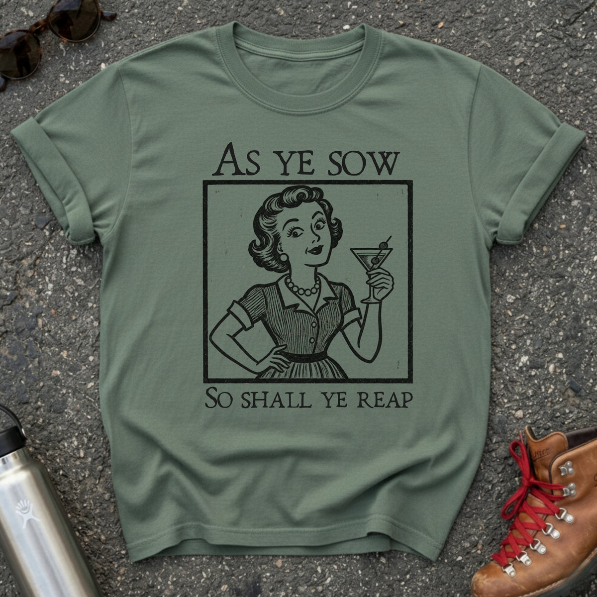 Comfort Colors t-shirt with a retro 1950s housewife raising a martini in vintage woodcut style and the words As Ye Sow So Shall Ye Reap