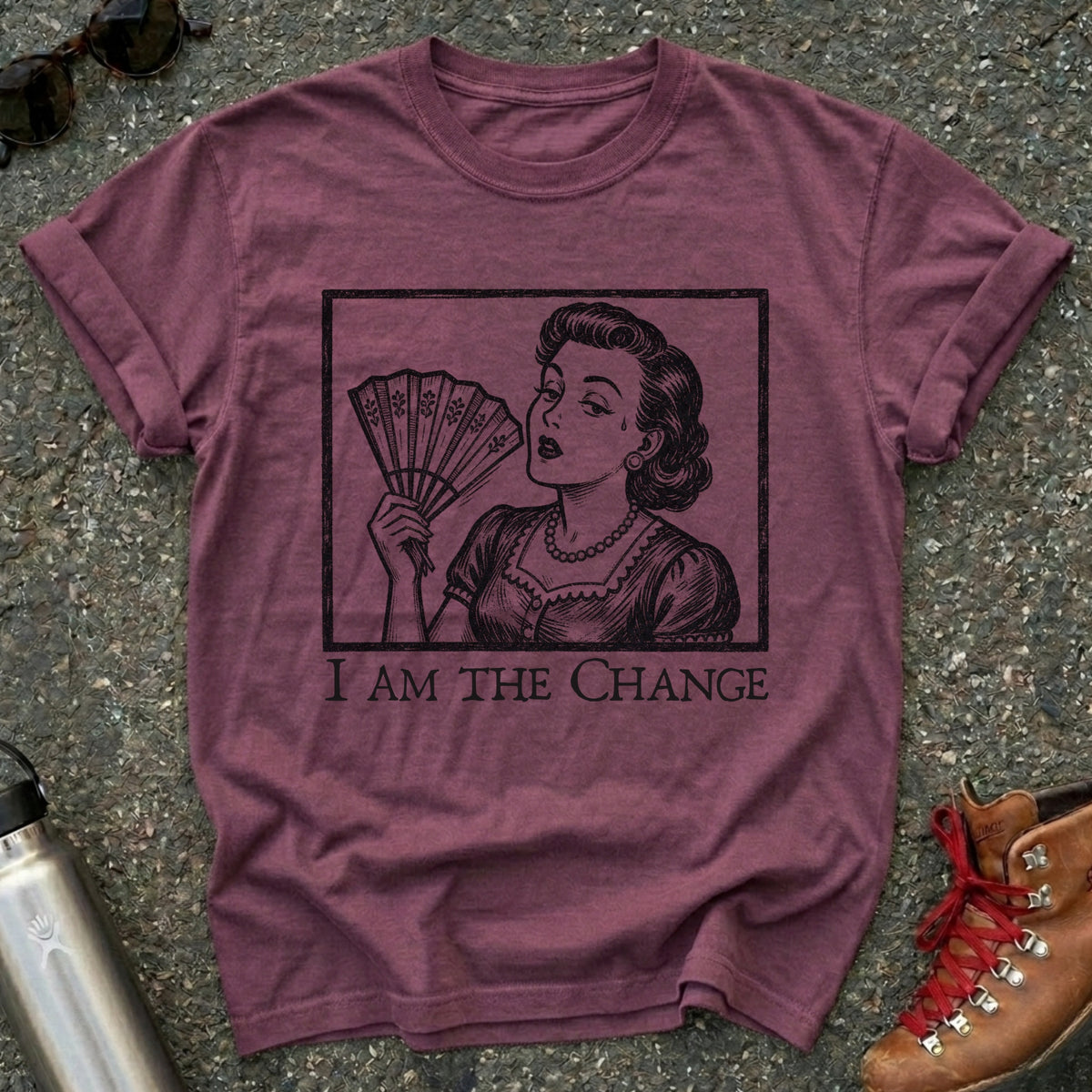 Comfort Colors t-shirt with a retro 1950s woman fanning herself in vintage woodcut style and the words I Am the Change