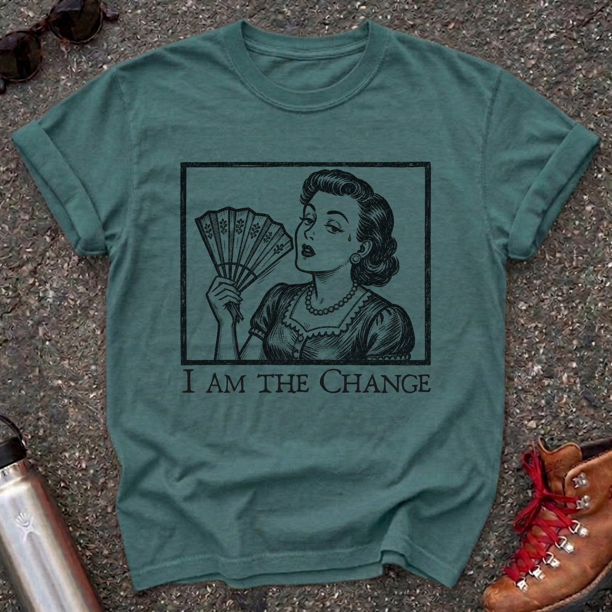 Comfort Colors t-shirt with a retro 1950s woman fanning herself in vintage woodcut style and the words I Am the Change