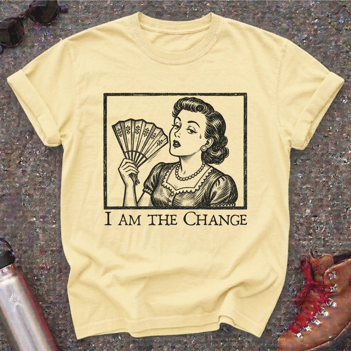 Comfort Colors t-shirt with a retro 1950s woman fanning herself in vintage woodcut style and the words I Am the Change