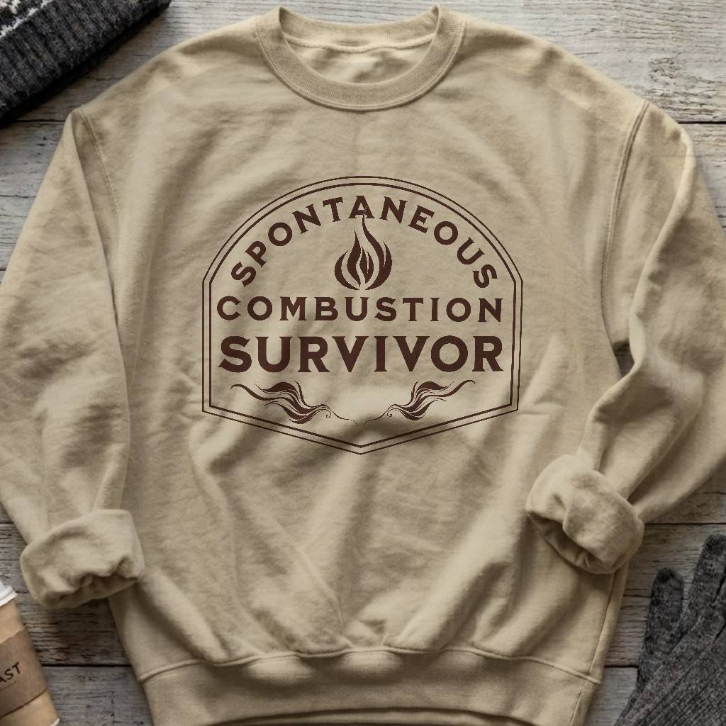 Crewneck sweatshirt with a vintage flame badge reading Spontaneous Combustion Survivor