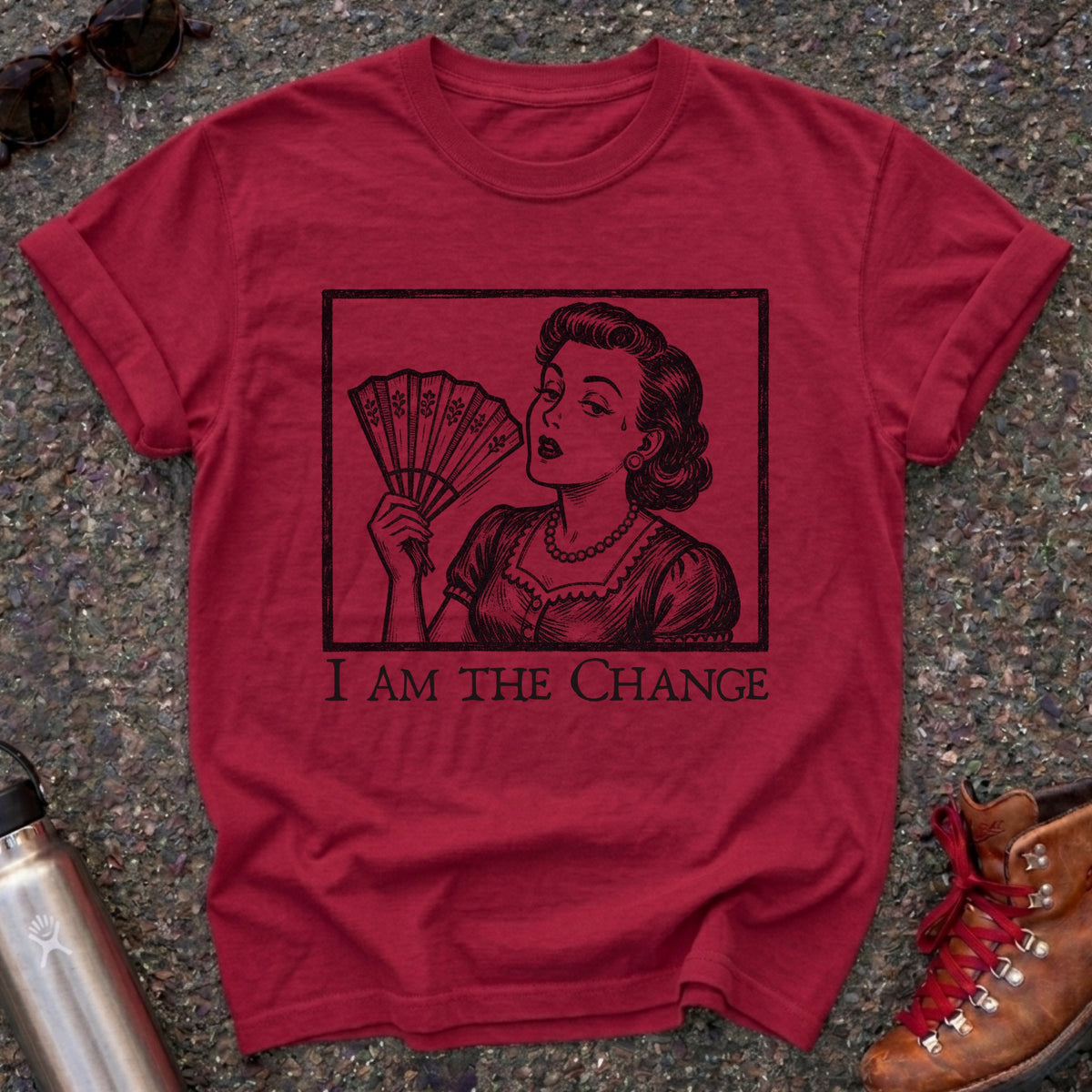 Comfort Colors t-shirt with a retro 1950s woman fanning herself in vintage woodcut style and the words I Am the Change