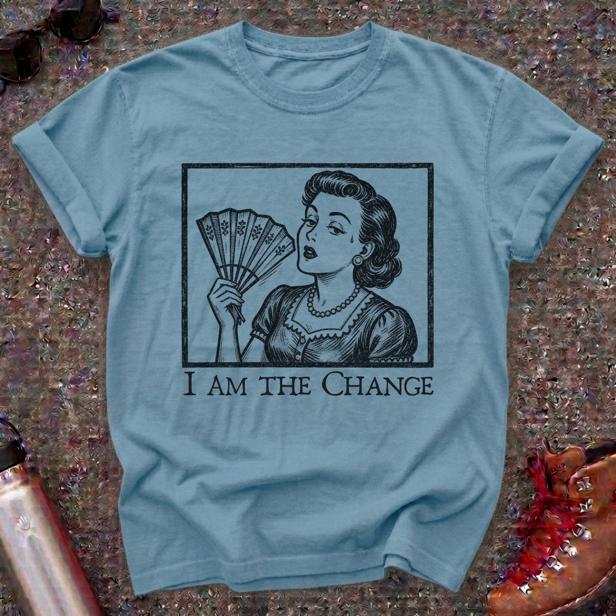 Comfort Colors t-shirt with a retro 1950s woman fanning herself in vintage woodcut style and the words I Am the Change