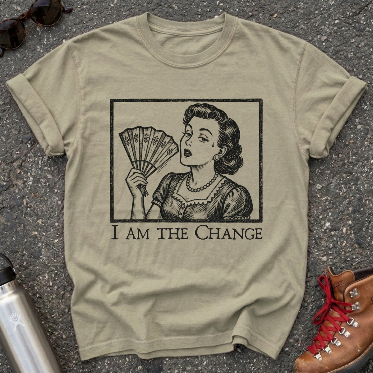 Comfort Colors t-shirt with a retro 1950s woman fanning herself in vintage woodcut style and the words I Am the Change