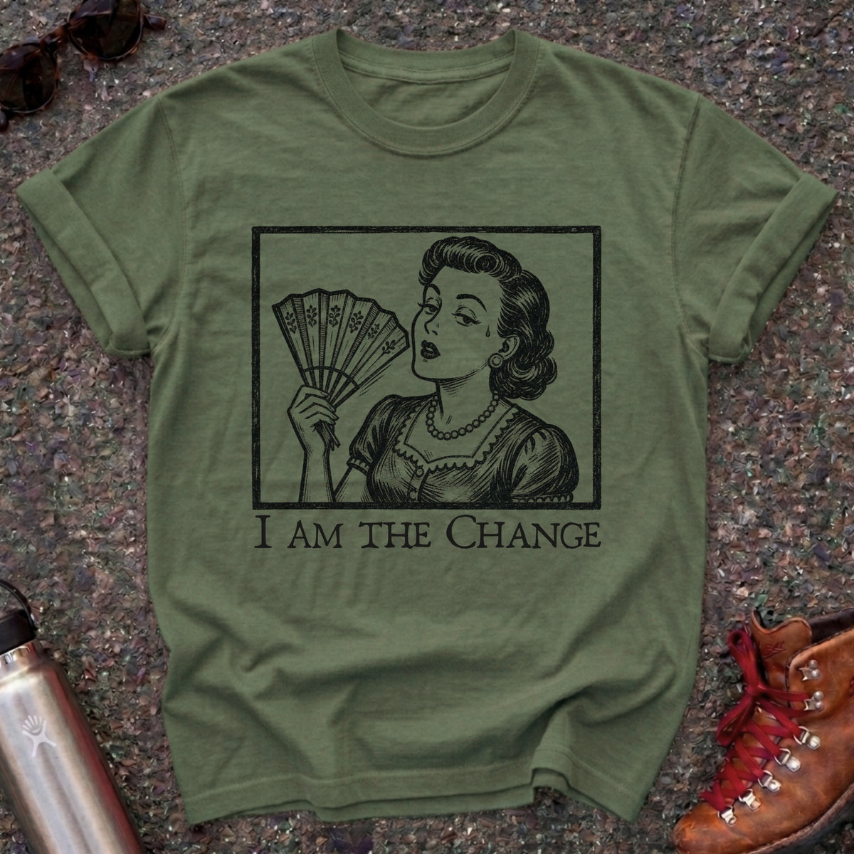 Comfort Colors t-shirt with a retro 1950s woman fanning herself in vintage woodcut style and the words I Am the Change
