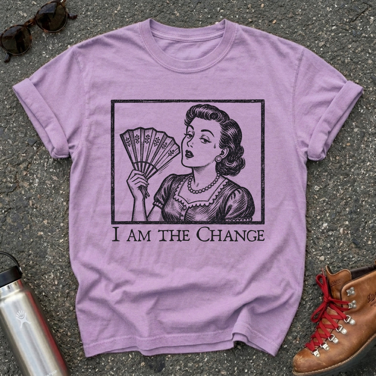 Comfort Colors t-shirt with a retro 1950s woman fanning herself in vintage woodcut style and the words I Am the Change