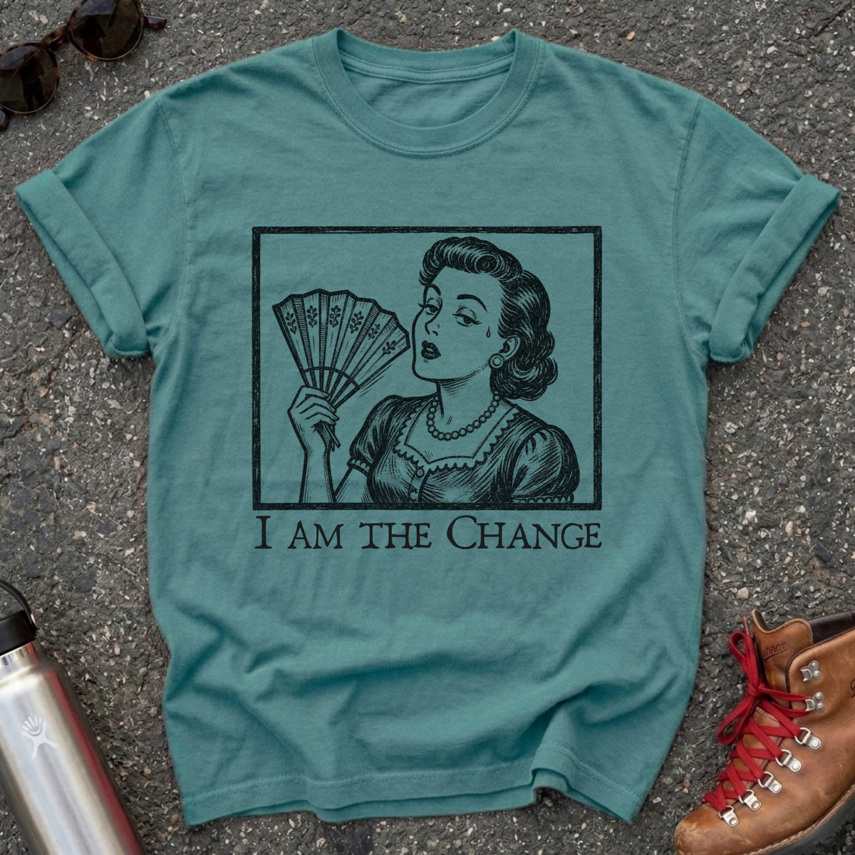 Comfort Colors t-shirt with a retro 1950s woman fanning herself in vintage woodcut style and the words I Am the Change